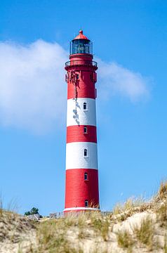 Amrum lighthouse in front of a dune landscape by Alexander Baumann