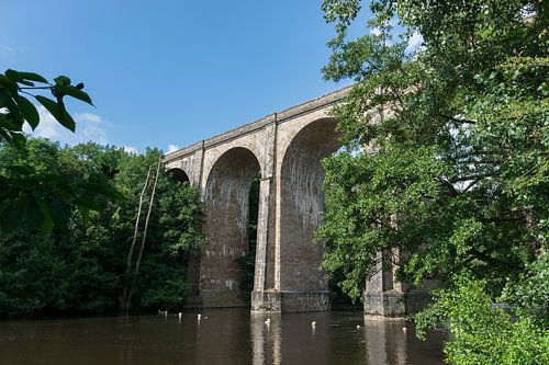 Old train viaduct over a small river in France