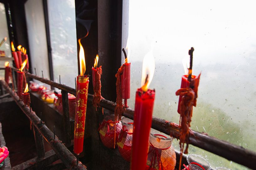 Burning red candles in Chinese Buddhist temple by Ger Beekes