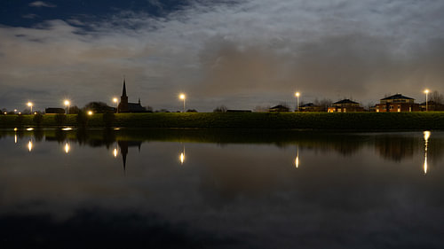 Heteren church on the dike with a full moon