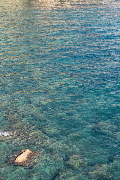 Clear sea water in a rocky bay by Adriana Mueller