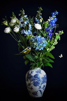 Still life flowers in a delft blue vase with blue tit