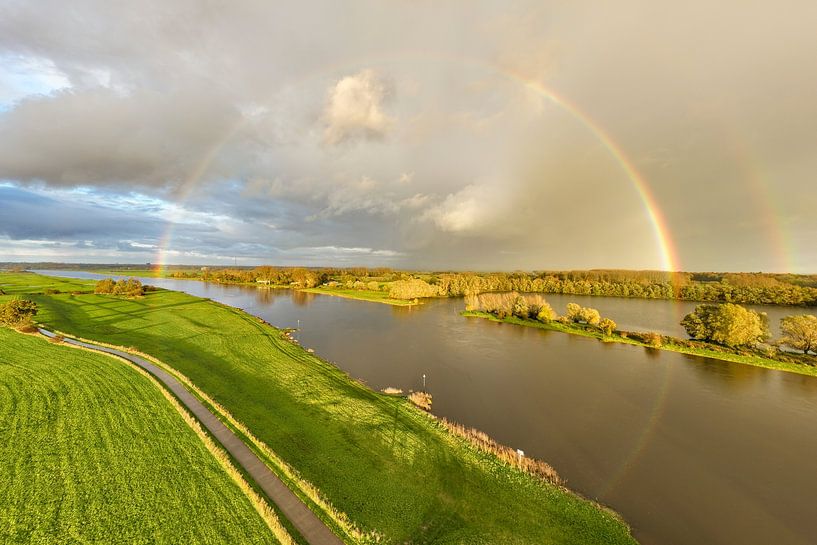 Rainbow during an autumn rain shower over the river IJssel by Sjoerd van der Wal Photography