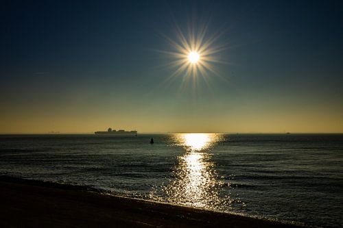 Cargo ship near Vlissingen with the sun setting