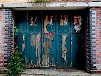 Dark blue garage door with peeling paint