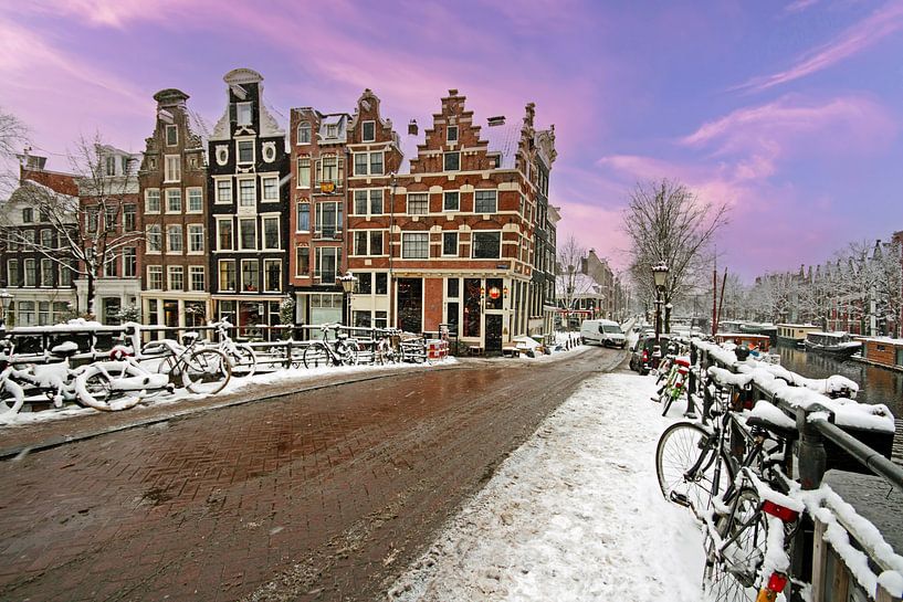 Snow-covered Amsterdam in the Netherlands in winter at sunset by Eye on You
