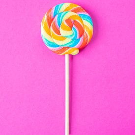 Rainbow colours on a lollipop on a bright pink background art print by Christa Stroo photography