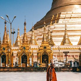 Buddhist monk with stools at the golden Shwedagon Pagoda in Yangon (Rangoon), Myanmar by Michiel Dros