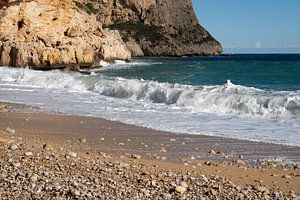 Schäumende Wellen treffen auf den Strand