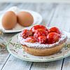 Close-up of a strawberry pie with its ingredients by John Kreukniet