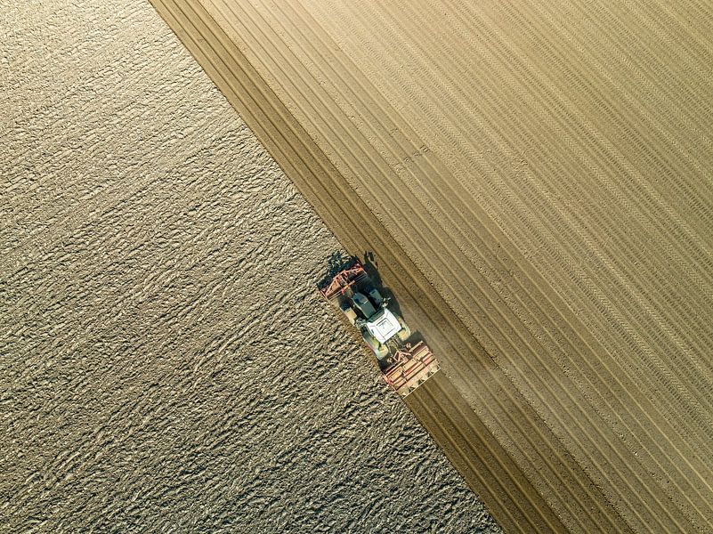 Tractor preparing the soil for planting crops by Sjoerd van der Wal Photography