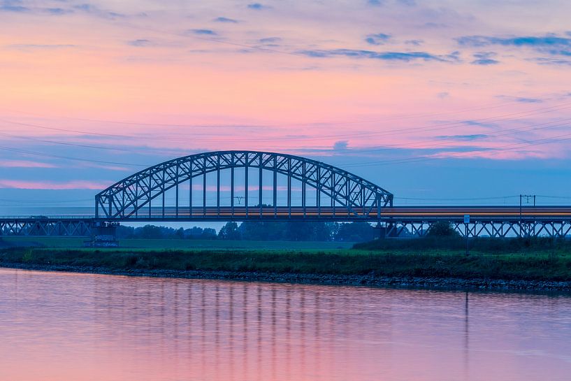 Train on Railroad Bridge after Sunset by Thijs Vermeer