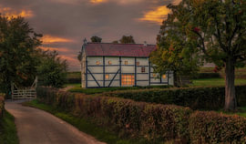 An evening photo of a half-timbered cottage in South Limburg