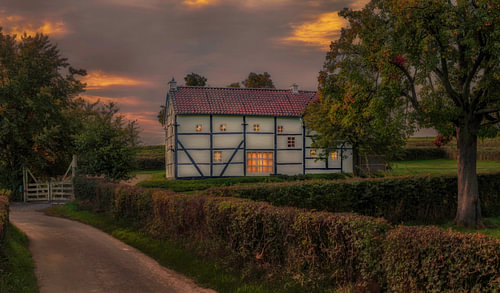 An evening photo of a half-timbered cottage in South Limburg