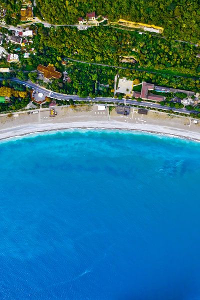 Photos from a great height. Aerial view from top to bottom of the turquoise sea with green trees. Ab by Michael Semenov