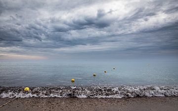 Row of buoys on the ocean against stormy sky by VIDEOMUNDUM