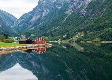 rood houten huis aan een fjord