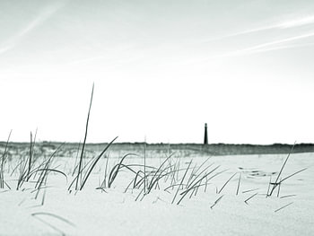 Beach with a lighthouse in soft shades