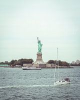 Statue of Liberty is passed by sailboat