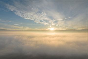 Sky above the clouds with sunlight over the fluffy clouds by Sjoerd van der Wal Photography