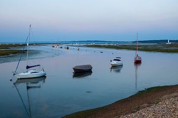 Ribbon of boats at sunset by Jos van den Berg