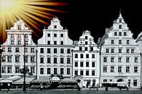 Surealistic view of four medieval facades of houses in Cracow captured in black and white with a bri