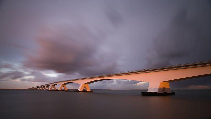 De Zeelandbrug bij ondergaande zon van Jan Jongejan