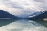 Reflection of mountains with snow in Moose Lake, Canada