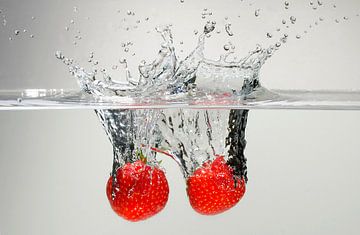 Two strawberries in water van Focco van Eek