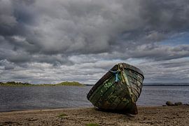 Old rowing boat on the beach by Jan de Jong