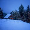 cozy village house on hill in winter night, Slovenia by Olha Rohulya
