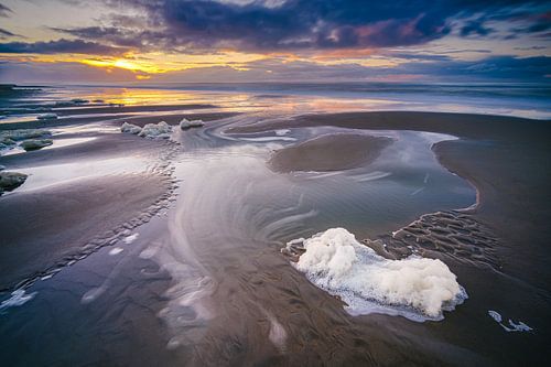 Foam on the beach during sunset