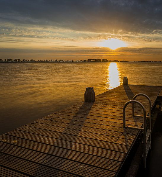 sunrise jetty in alkmaarder lake by peterheinspictures