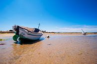 boat on sand with waves by Youri Mahieu thumbnail