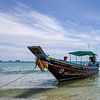 Colorful traditional fishing boat on the tropical beach of Koh Pangnan, Thailand by Tjeerd Kruse