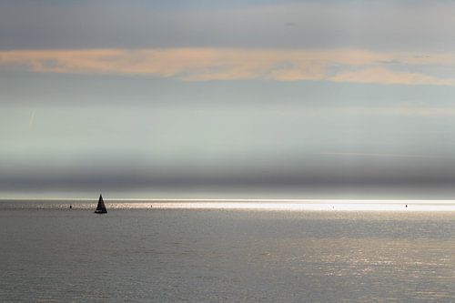 Sunbeams and sailing yacht at sea