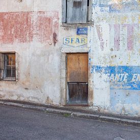 A weathered façade featuring a Vittel advertisement in France by Blond Beeld