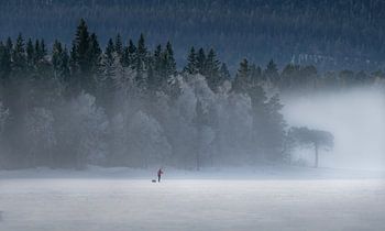 Moving with the pulka on frozen lake Ottsjon after ice fishing