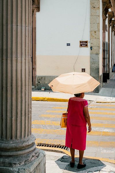 Mexican woman with yellow umbrella. by Frank Aardema