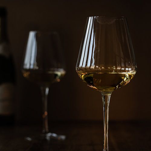 Atmospheric white wine glasses in lowkey