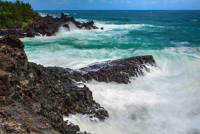 Volcanic rocky coast with storming sea by Yevgen Belich