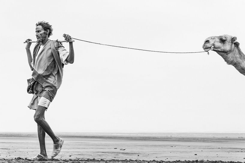 Man with his camel on his way to a salt lake in Ethiopia by Photolovers reisfotografie