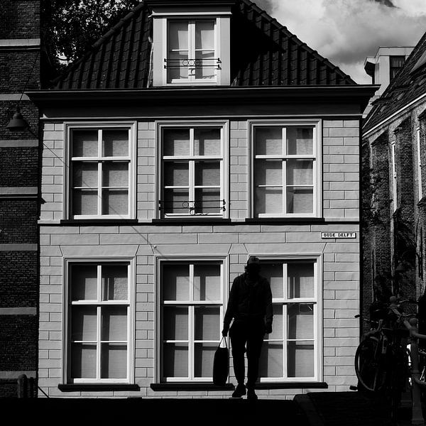 Silhouette of man with shopping bag on Oude Delft by Rini Braber