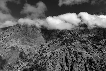 A dramatic black-and-white mountain landscape with rolling clouds on La Palma