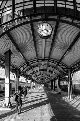two female travelers wait for the train 