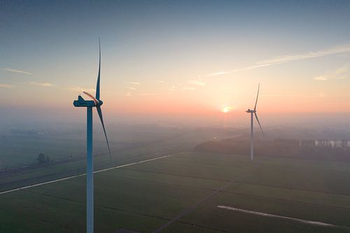 Wind turbines producing sustainable energy during sunrise by Sjoerd van der Wal Photography