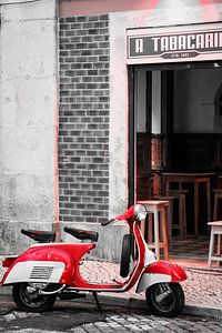 Een rode Vespa in een Portugees straatje