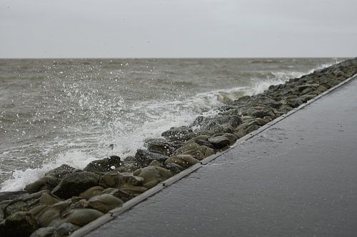 Waves beat against the dike