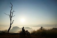 Un motocycliste profite du lever du soleil en Thaïlande