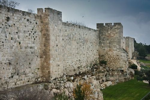Medieval walls of Jerusalem. Ancient stone, gloomy sky. Gloomy walls of Jerusalem